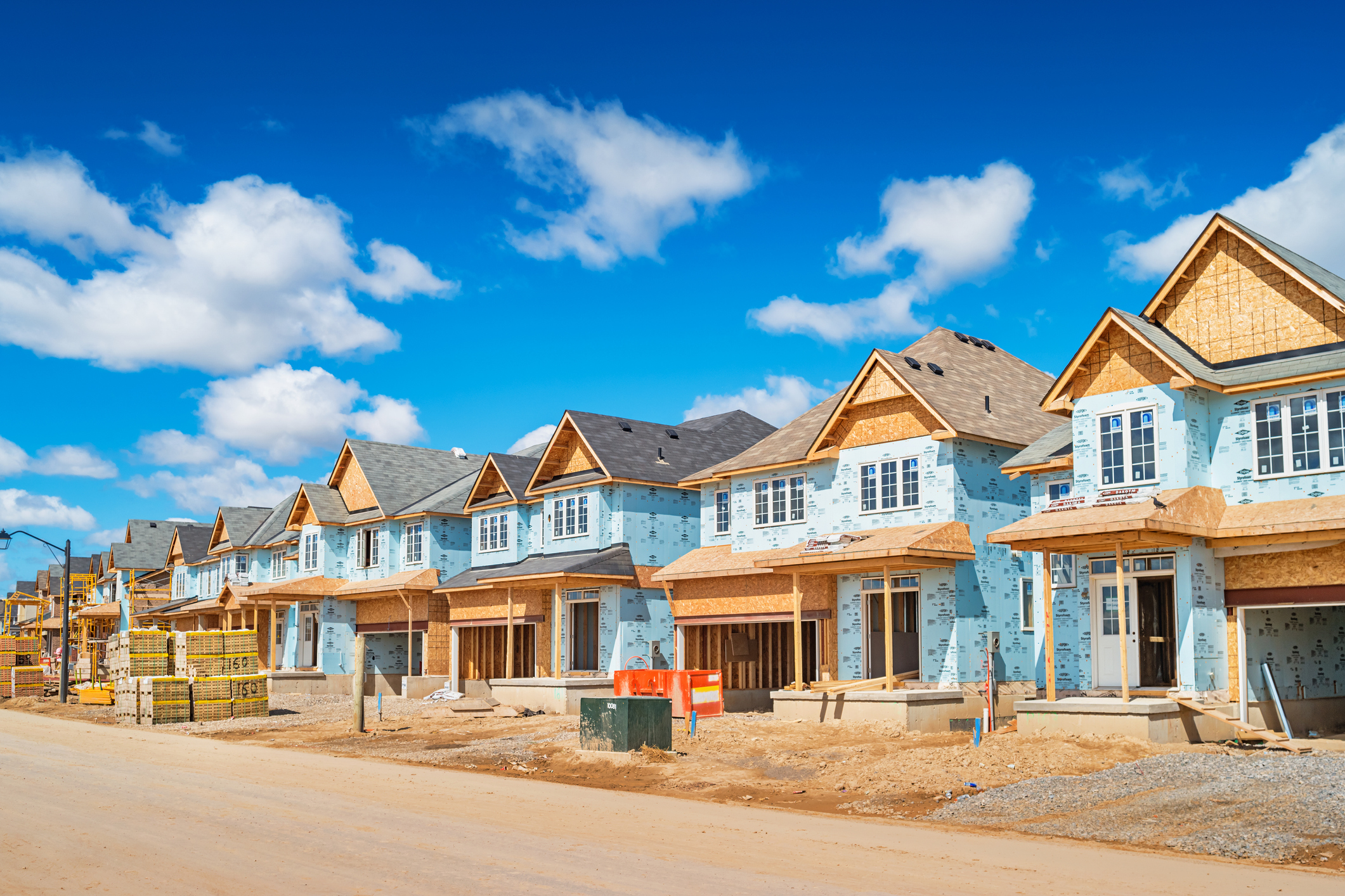 New houses are under construction in a new residential district in Brantford Ontario Canada on a sunny day.